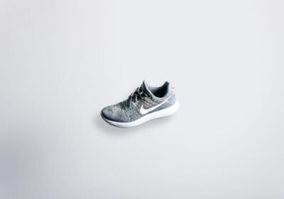 unpaired gray and white Nike Flyknit shoe