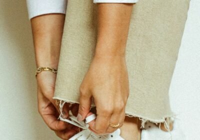 woman in white pants wearing silver and gold bracelet