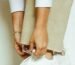 woman in white pants wearing silver and gold bracelet